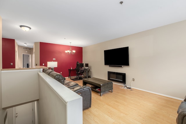 living room with hardwood / wood-style floors and a notable chandelier