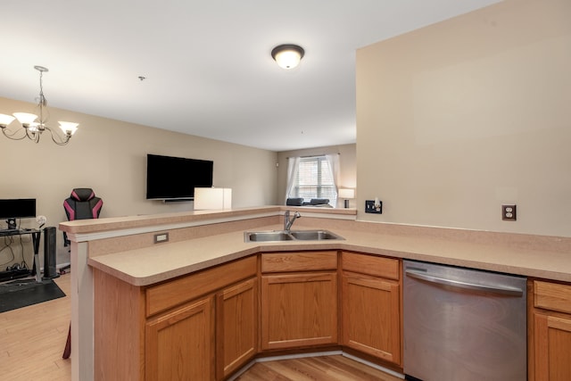 kitchen featuring an inviting chandelier, sink, light hardwood / wood-style flooring, stainless steel dishwasher, and kitchen peninsula