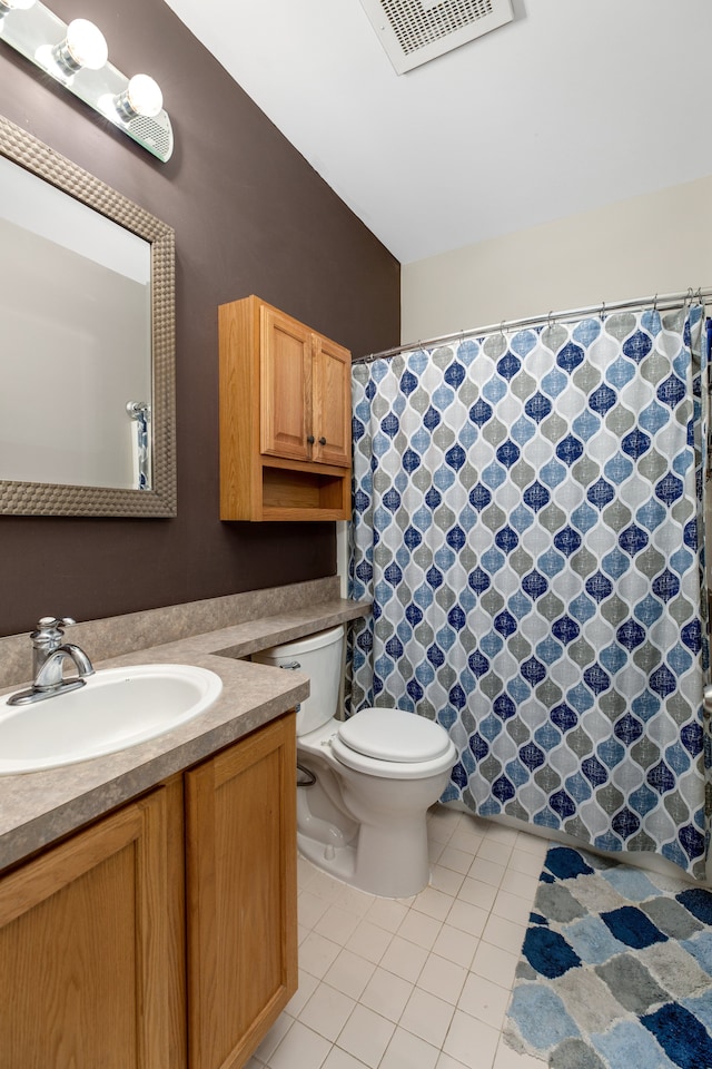 bathroom with tile patterned floors, vanity, and toilet