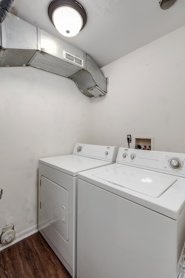 laundry room with dark hardwood / wood-style flooring and separate washer and dryer