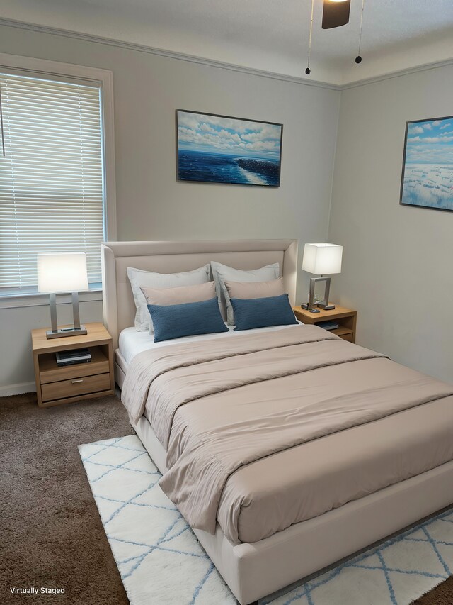 carpeted bedroom with ceiling fan and crown molding