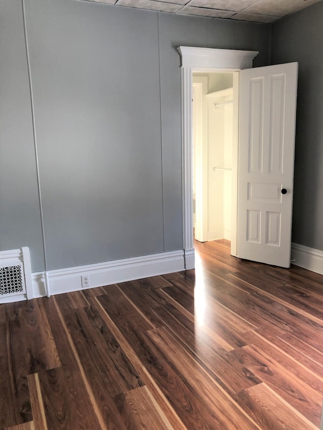 unfurnished room with dark hardwood / wood-style floors