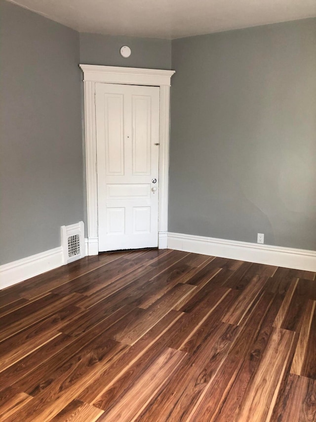 empty room with dark hardwood / wood-style floors