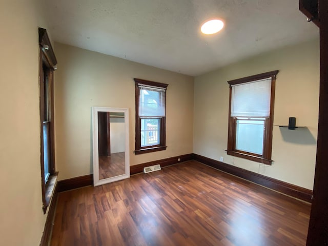 unfurnished bedroom featuring dark wood-type flooring