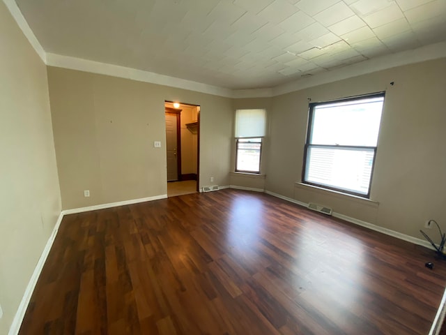 unfurnished room with dark hardwood / wood-style floors