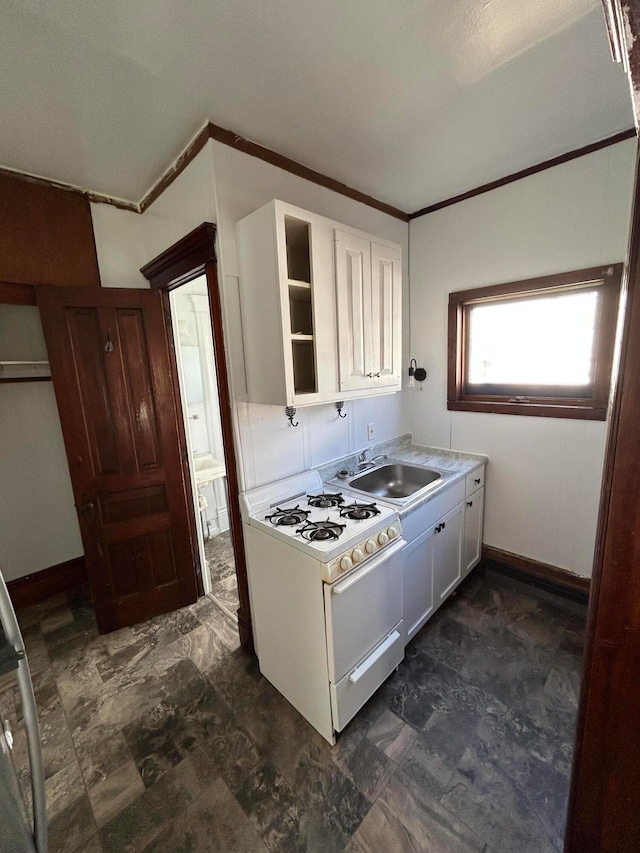 kitchen with white cabinetry, white gas range, ornamental molding, and sink