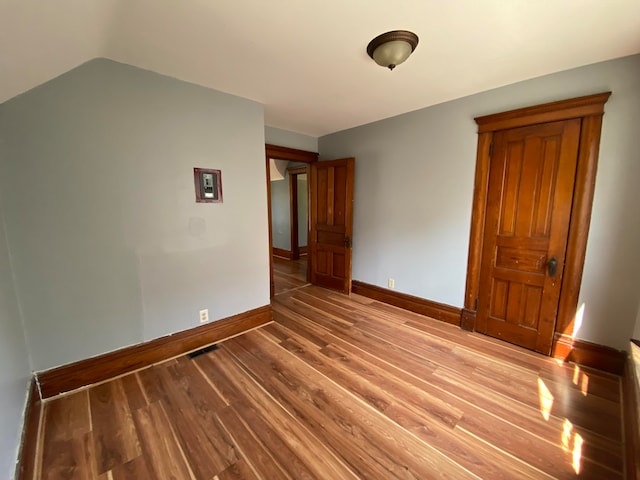 spare room featuring wood-type flooring