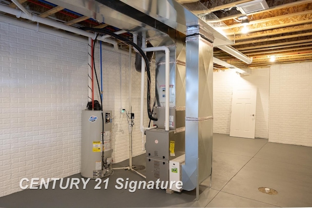 basement with heating unit, water heater, and brick wall