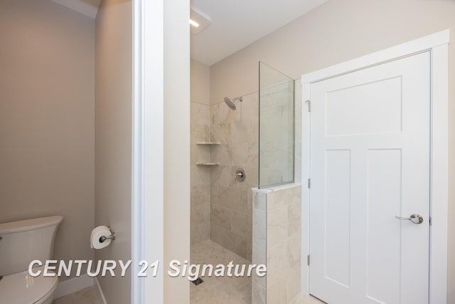 bathroom featuring toilet and tiled shower