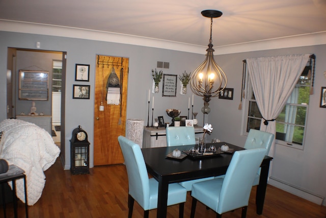 5831 Stadium Dr, Kalamazoo, MI 49009 - dining space with baseboards, visible vents, wood finished floors, and a notable chandelier