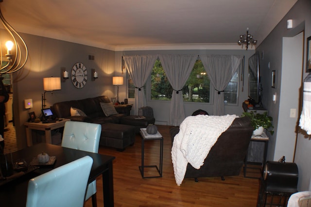 5831 Stadium Dr, Kalamazoo, MI 49009 - living area featuring visible vents, a baseboard radiator, wood finished floors, and a chandelier