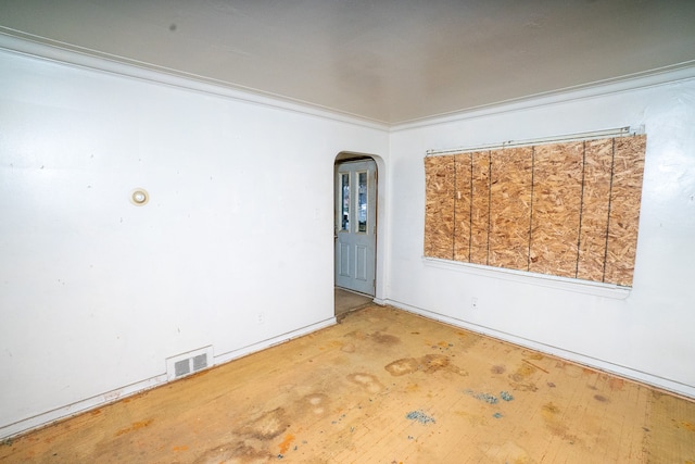 unfurnished room featuring ornamental molding