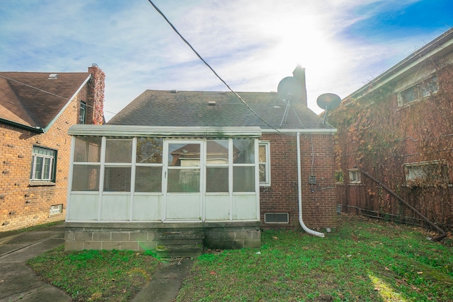 4224 W Davison, Detroit, MI 48238 - back of house featuring a sunroom, roof with shingles, brick siding, and a chimney