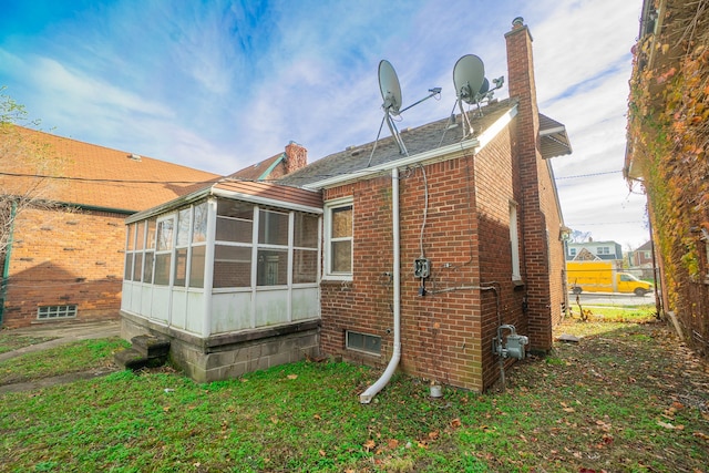 4224 W Davison, Detroit, MI 48238 - rear view of property featuring a sunroom, brick siding, and a chimney