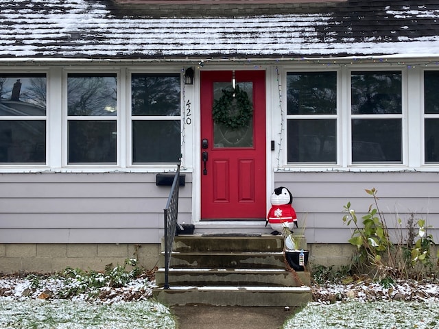 view of snow covered property entrance