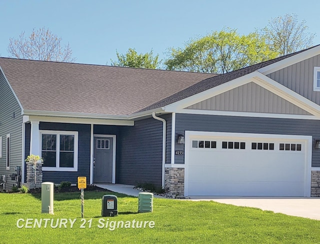 view of front of home with a garage and a front lawn