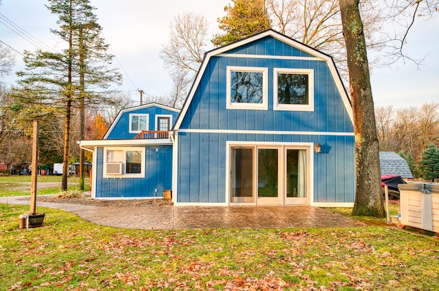 back of property featuring a patio and a yard