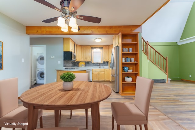 771 Hurley Dr, Howell, MI 48843 - dining area featuring stacked washing machine and dryer, stairs, ceiling fan, light wood-type flooring, and beam ceiling