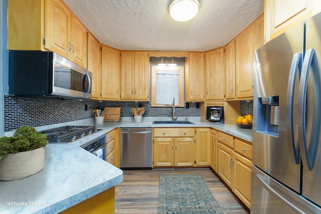 771 Hurley Dr, Howell, MI 48843 - kitchen with stainless steel appliances, a sink, light countertops, and backsplash