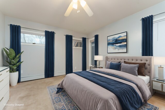 bedroom with ceiling fan and light colored carpet