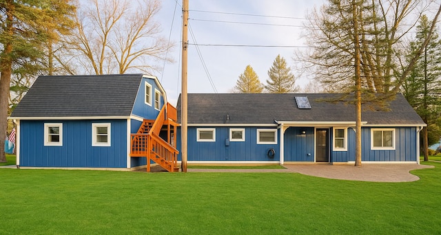 771 Hurley Dr, Howell, MI 48843 - view of front of house featuring stairs, a front yard, and board and batten siding