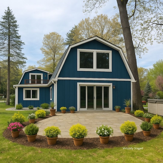771 Hurley Dr, Howell, MI 48843 - back of property with a gambrel roof, a patio, and board and batten siding
