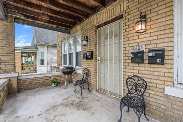 view of patio / terrace featuring a grill and a porch