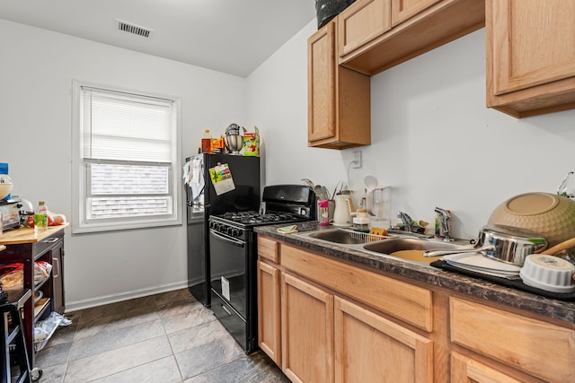 kitchen with black appliances, sink, and tile patterned floors