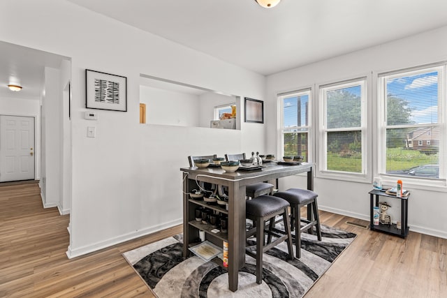 dining space featuring light wood-type flooring