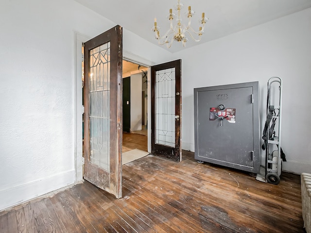 foyer entrance featuring dark hardwood / wood-style floors and an inviting chandelier