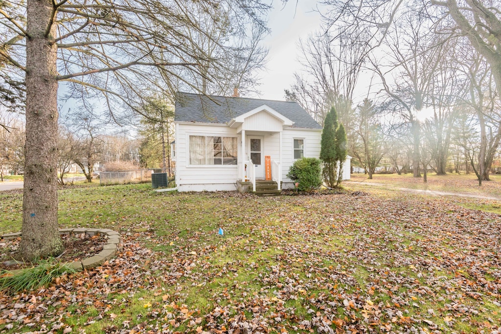 single story home featuring central AC unit