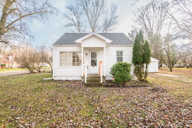 bungalow-style house with a front yard