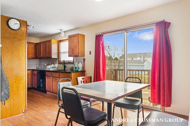 dining space with light hardwood / wood-style floors and sink