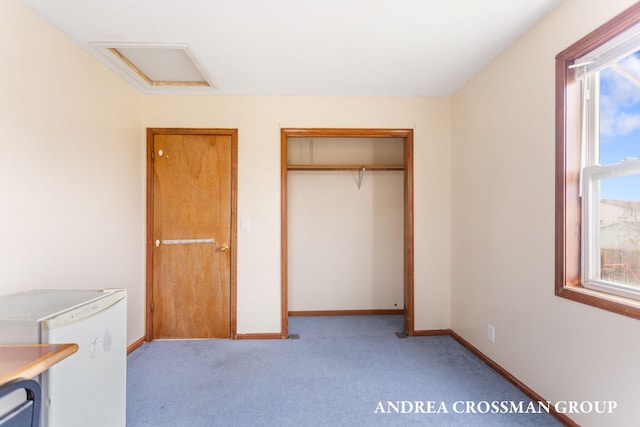 unfurnished bedroom with a closet, light carpet, and multiple windows