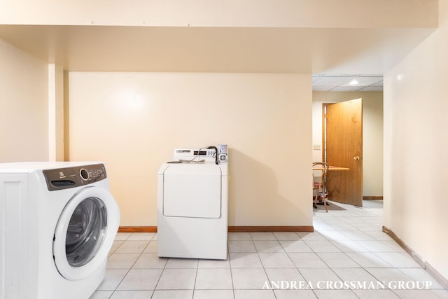 washroom featuring washer and clothes dryer and light tile patterned floors