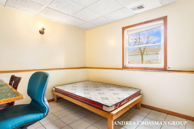 tiled bedroom with a paneled ceiling