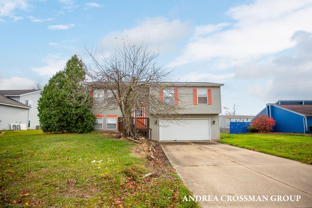 raised ranch with a front yard and a garage