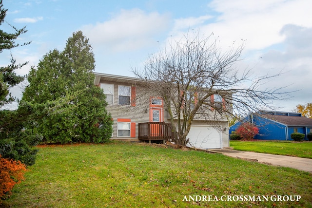 split foyer home with a front yard and a garage