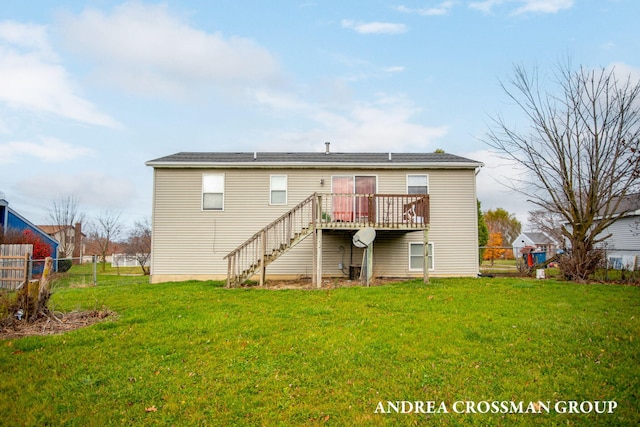 back of house featuring a yard and a deck