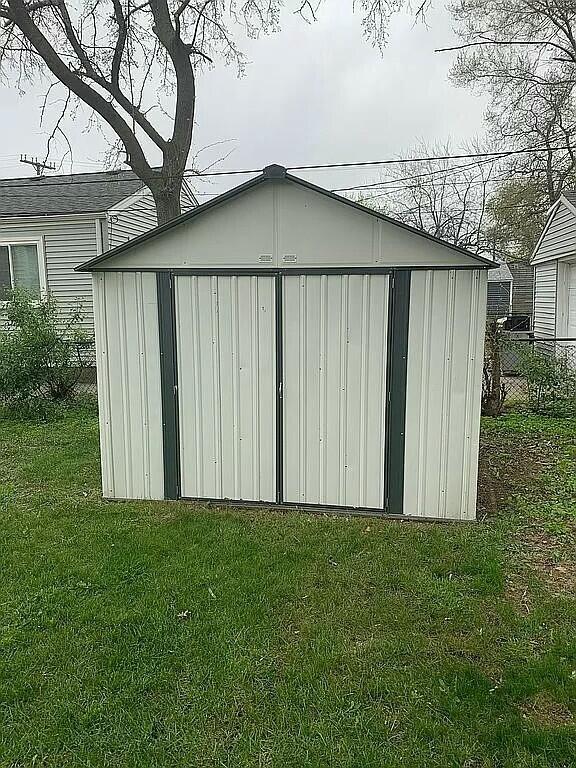 view of outbuilding featuring a yard