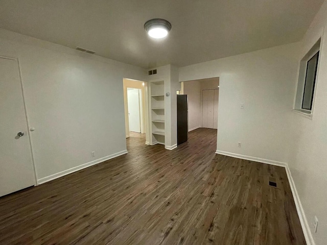 unfurnished bedroom featuring dark hardwood / wood-style floors