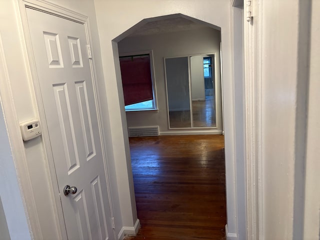 corridor with dark hardwood / wood-style flooring