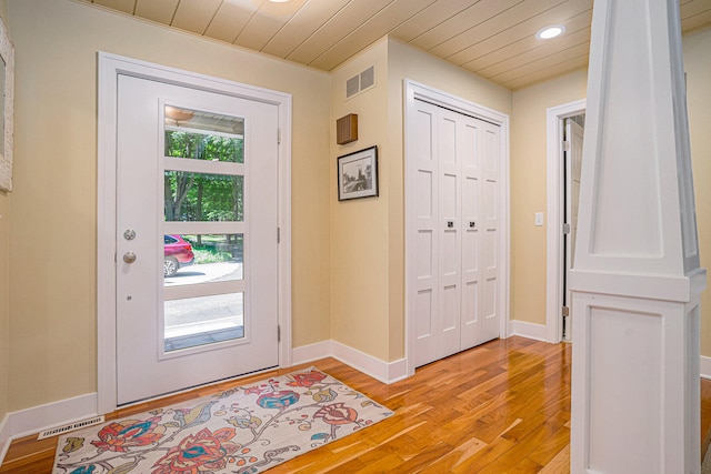 entrance foyer with light hardwood / wood-style flooring and wooden ceiling