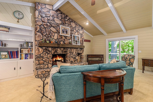 carpeted living room with vaulted ceiling with beams, wood walls, a stone fireplace, and wood ceiling