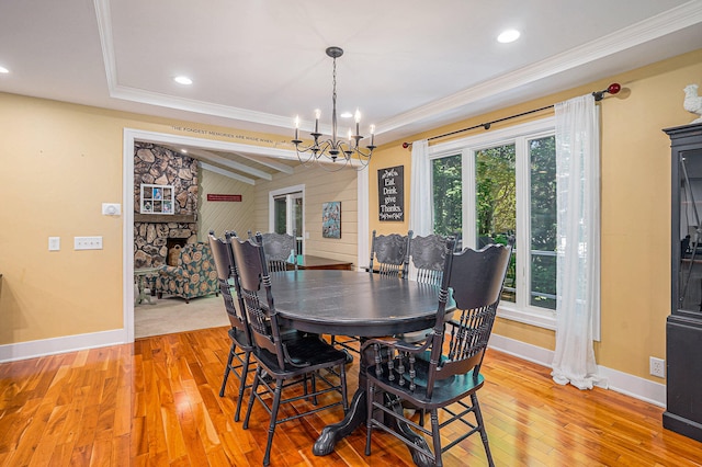 dining area featuring hardwood / wood-style flooring, an inviting chandelier, and crown molding