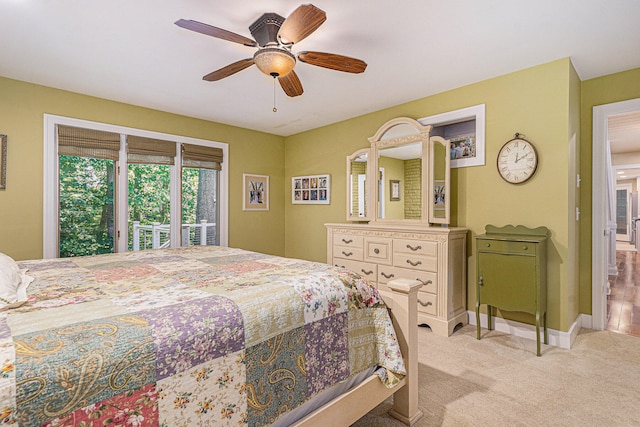 bedroom with ceiling fan, access to exterior, and light carpet