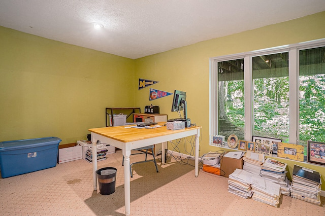 home office featuring a textured ceiling