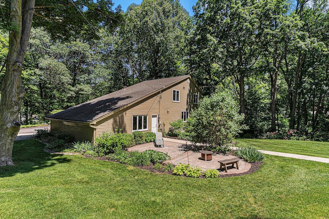 view of property exterior with a lawn and a patio area