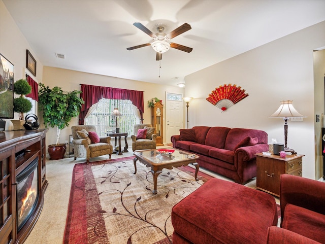 living room featuring light carpet and ceiling fan