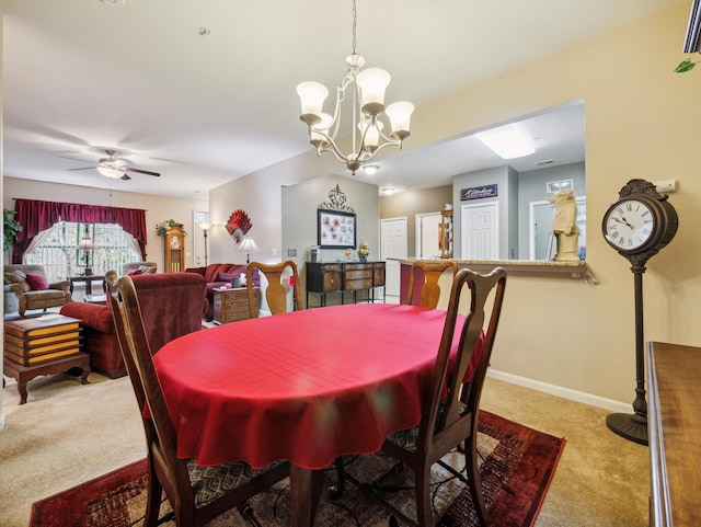 dining room with ceiling fan with notable chandelier and light carpet